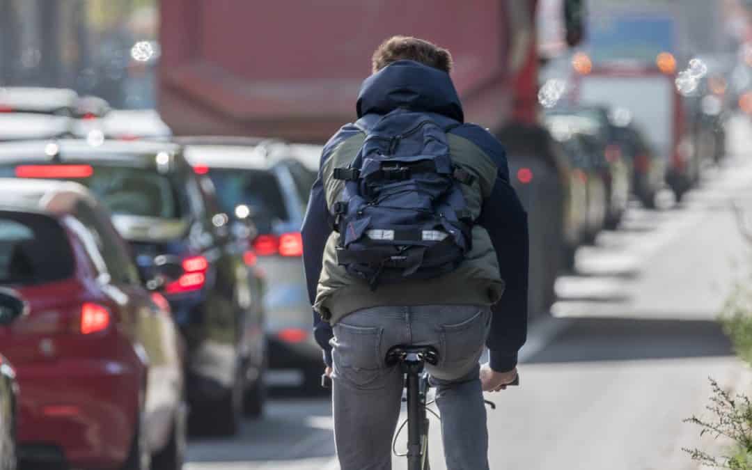 male,cyclist,passing,traffic,jam
