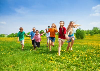 large,group,of,kids,running,in,the,dandelion,spring,field