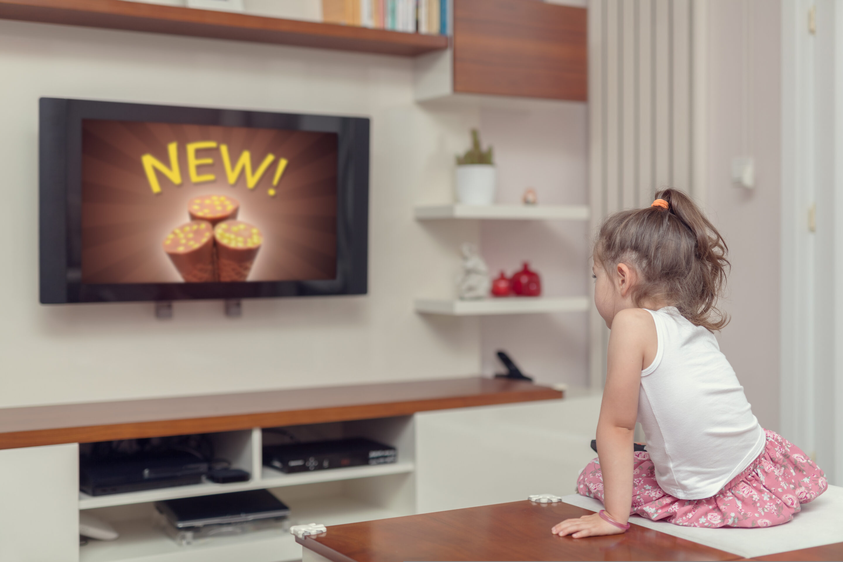 cute,little,girl,watching,advertisement,on,tv.,appropriate,content,for