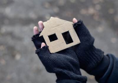 young,homeless,boy,holding,a,cardboard,house