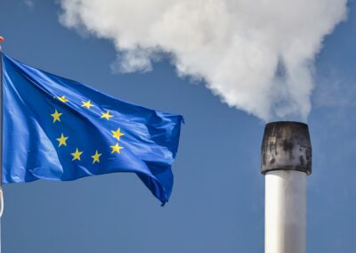 waving,european,flag,in,front,of,a,polluting,factory,chimney