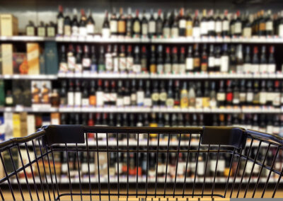 abstract,blurred,image,of,alcohol,store,with,trolley,(selective,focused