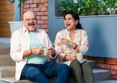 portrait,of,senior,indian,couple,sitting,on,sofa,or,stairs